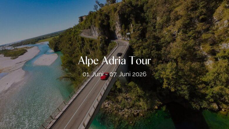 Header Bild der Alpe Adria Tour: Roter Sportwagen auf alpiner Straße über türkisblauem Fluss.