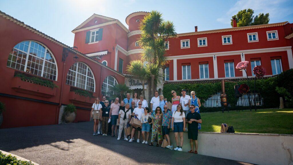 Gruppe von Fahrern vor einem luxuriösen Hotel an der Côte d’Azur.